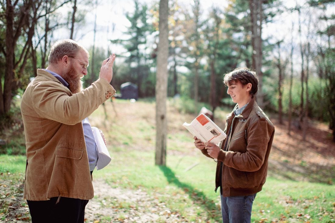 A tutor giving a student individual guidance on his Latin reading